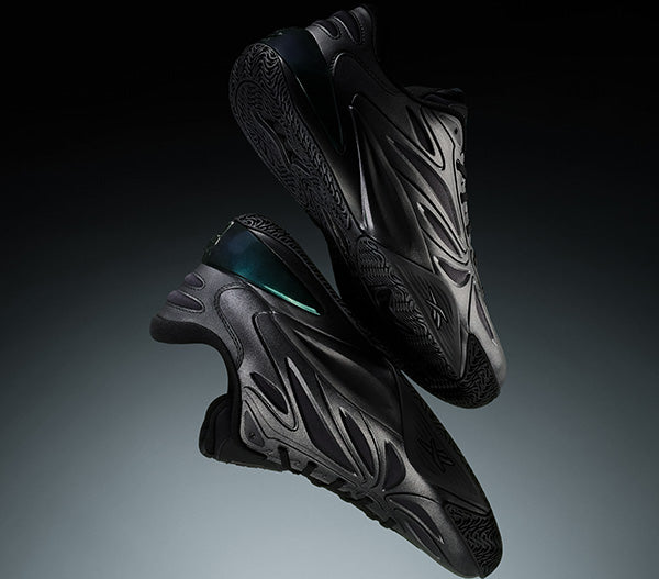 Black athletic shoes with unique design on a gradient background