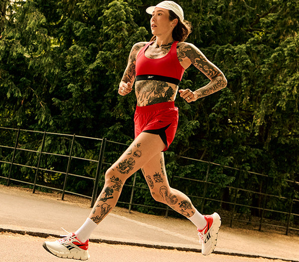 woman in red wearing running shoes