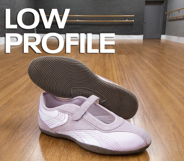 Pink shoe with a low profile sole on a wooden floor, with 'LOW PROFILE' text above.